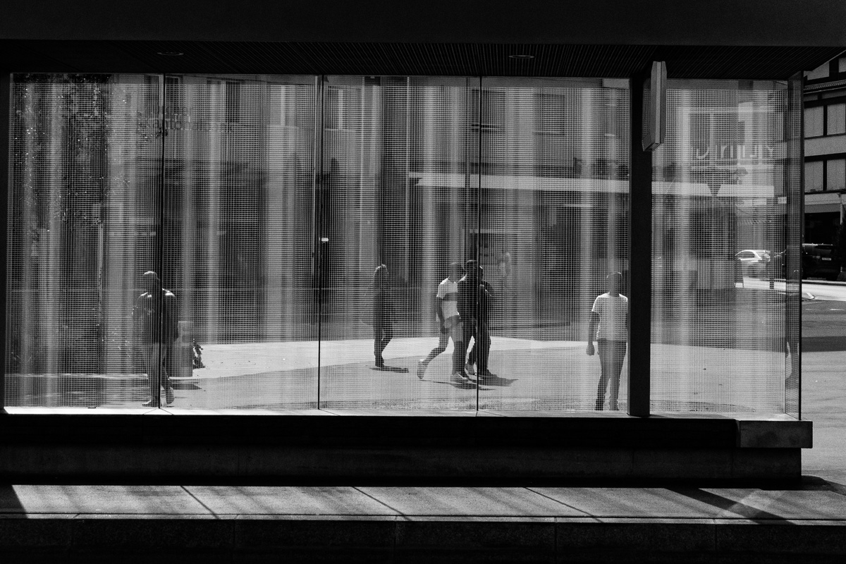 people-behind-busstop-window-with-texture